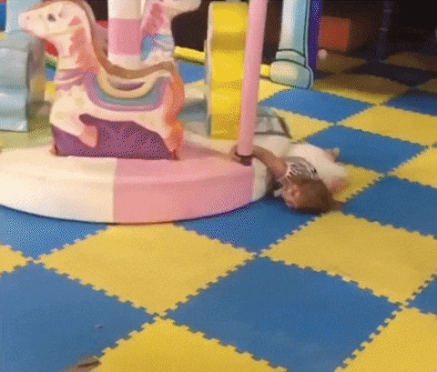 Criança com sono dormindo em brinquedo carrossel
